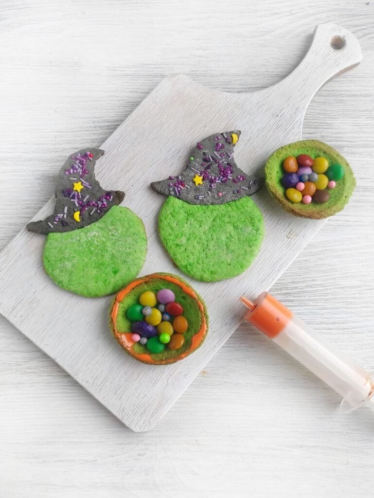 Step 4: Assembling creative desserts by filling green cookie cups with colorful candies and sealing with orange chocolate.