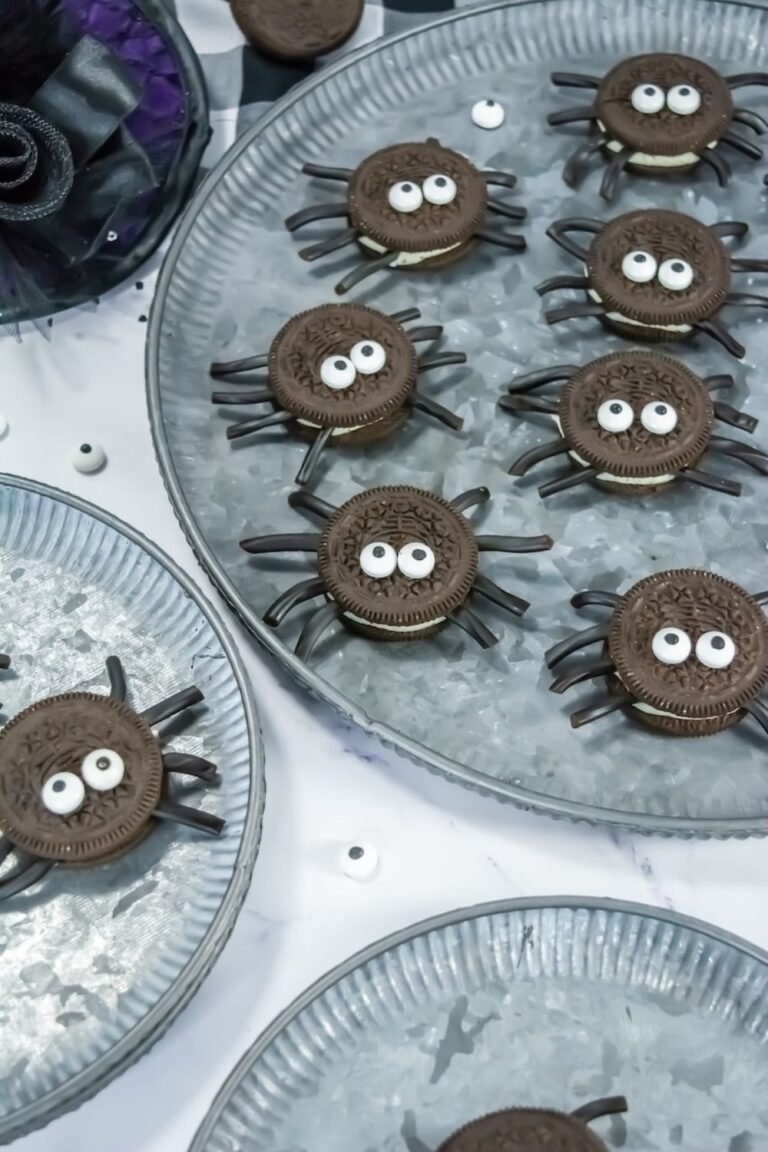 Oreo Spider Cookies with candy eyes and licorice legs arranged on a galvanized serving tray, a fun no-bake Halloween treat for parties and kids.