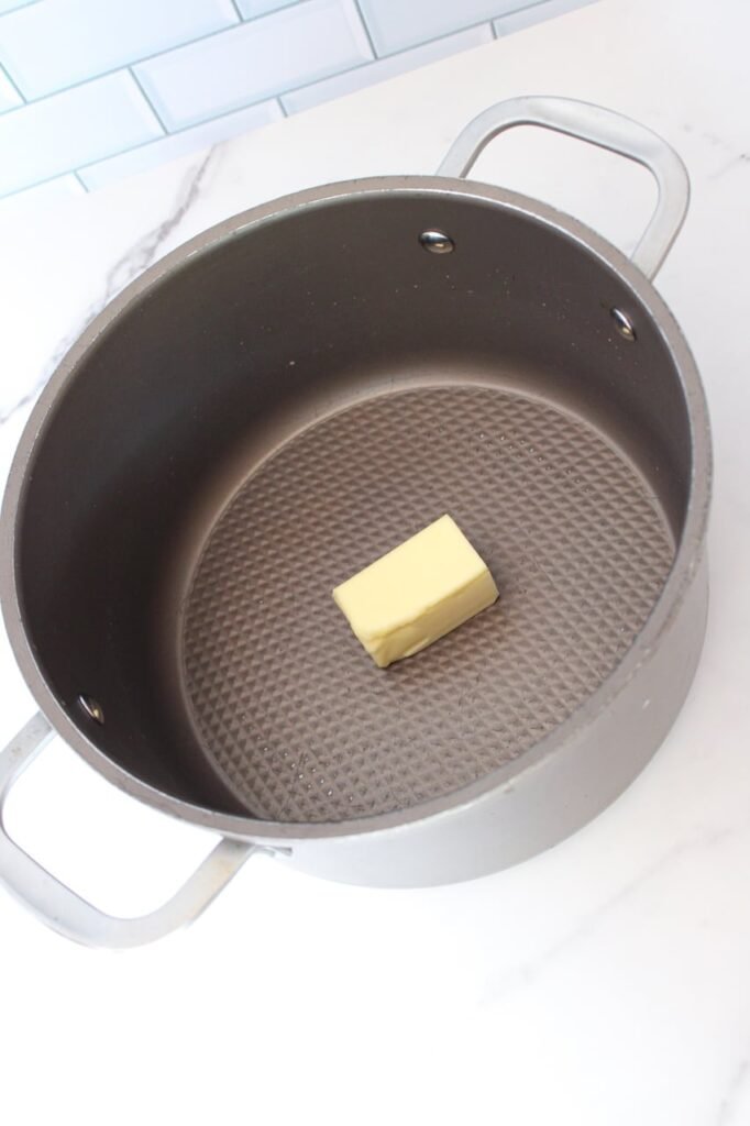 Step one for making Frankenstein Rice Krispie treats: melting butter in a pot before adding marshmallows.