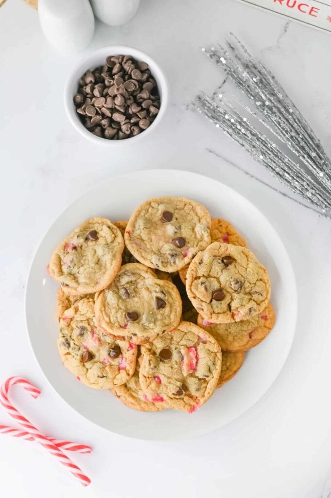 Christmas chocolate chip cookies with peppermint and crushed candy canes arranged on a plate for holiday baking.