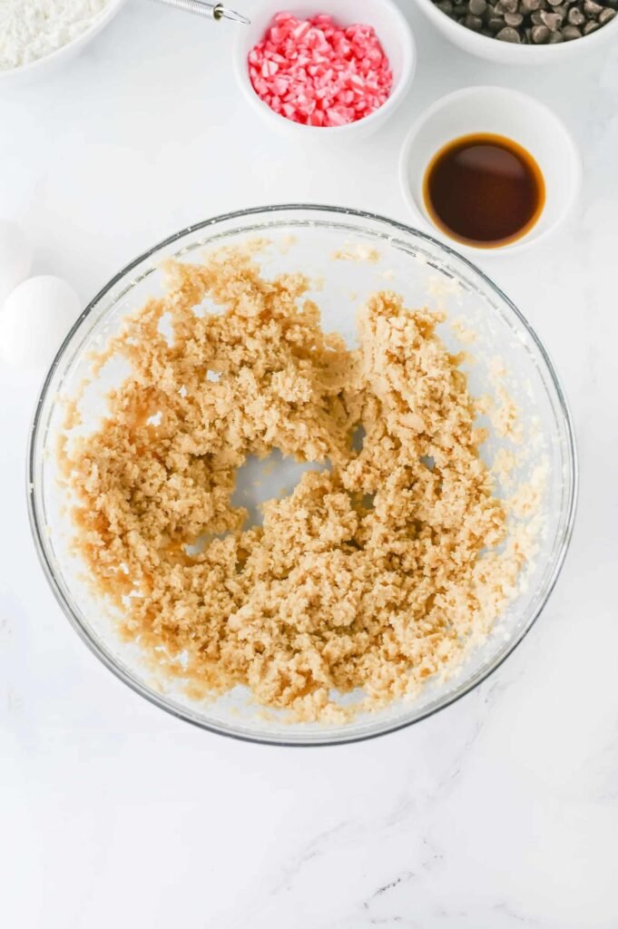 Creamed butter and sugar mixture in a glass bowl.