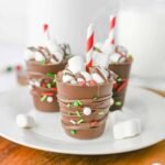 Featured image of homemade hot chocolate sticks decorated with marshmallows and Christmas sprinkles, ready to stir into warm milk.