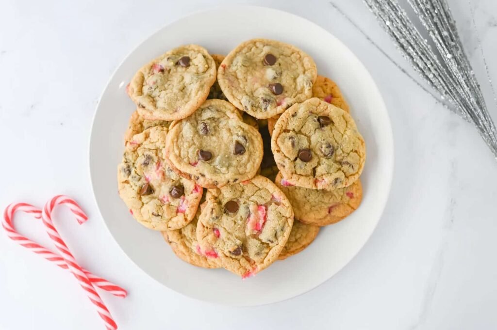 Holiday mint chocolate chip cookies with crushed candy canes on a white plate for Christmas baking.