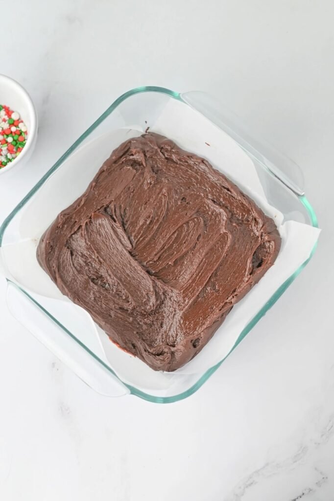 1st layer spread evenly in a parchment-lined glass pan, chilling before adding the white chocolate layer.