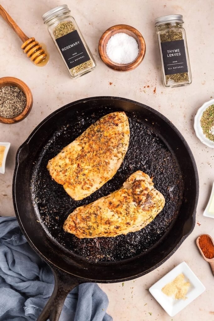 Golden-brown seared in a cast-iron skillet, seasoned with herbs and ready to go into the oven for roasting.