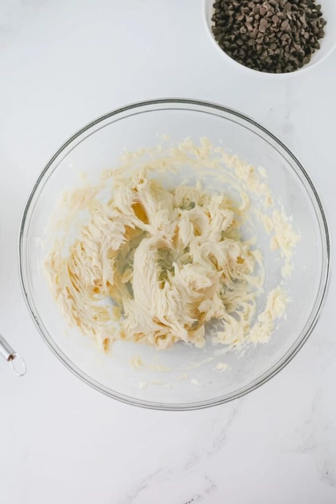 Creamed butter and powdered sugar in a glass bowl while making christmas treats.