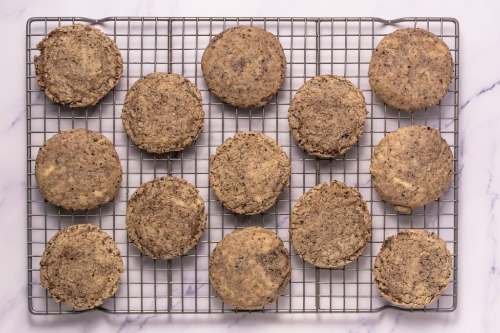 Freshly baked dessert and with visible Oreo crumbs cooling on a wire rack after baking before adding frosting.