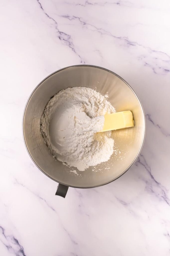 Stand mixer bowl with softened butter and granulated sugar before creaming together to make dough.