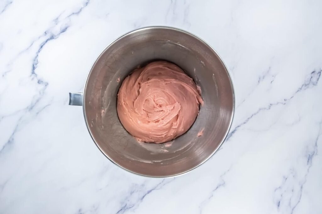 Mixing bowl with smooth strawberry cookie dough fully combined, showing thick and creamy texture ready for baking strawberry shortcake cookies.