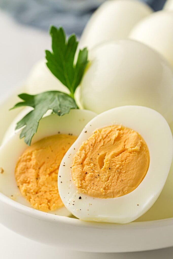 Close-up of sliced hard-boiled eggs with firm white and bright yellow yolks, lightly seasoned and ready to serve.