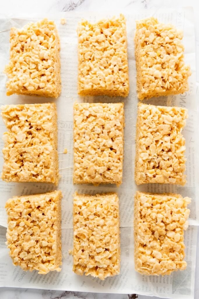 Overhead view of independence dessersts cut into even rectangular squares and arranged on parchment paper.