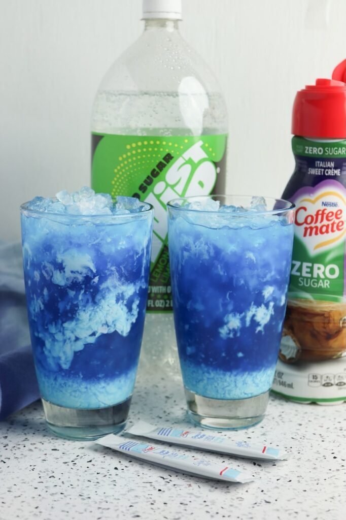 Two glasses with sweet cream swirling through the drink, creating a marbled effect over ice