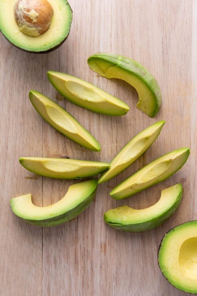 Fresh wedges sliced on a wooden cutting board for before breading and cooking.